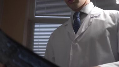 Kapatın. MRI, x-ışını görüntüleri. Doktor manyetik rezonans terapisi film sonuçlarını analiz eder. 4k