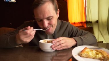 bir kase sıcak chili con carne buğulaması. lobio. bir adam sıcak bir tabak fasulye yiyor. 4k, buhar sıcak yemek.