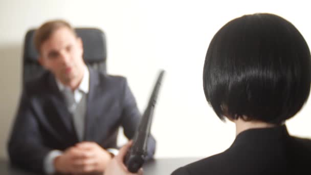 Un homme en costume pose des questions à une femme brune lors d'une interview. 4k. entretien. recrutement — Video