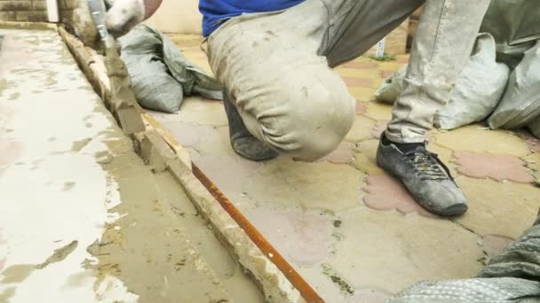 Spatula and bucket with mortar on the construction site. the builder finishes the surface with plaster. 4k. — Stock Video