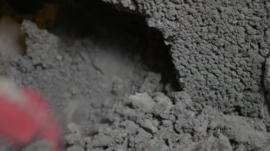 bir inşaat alanında, bir işçi bir perforator duvara vurma. 4k
