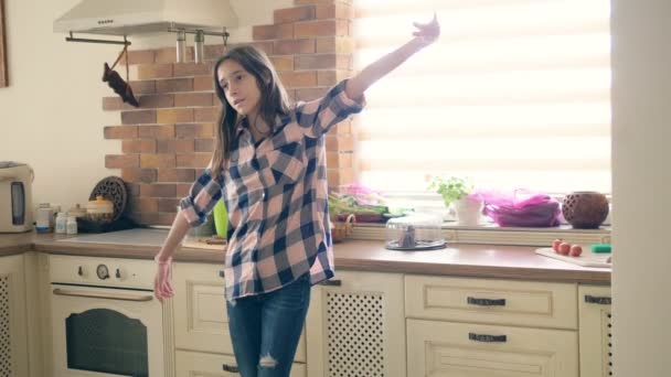 Mooi brunette tiener meisje dansen plezier in de keuken. — Stockvideo
