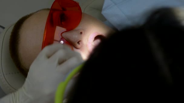 Zbliżenie. Kobieta odwiedza dentystę. ręce dentysty w rękawiczkach — Wideo stockowe