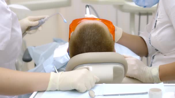 Επίσκεψη μιας γυναίκας στον οδοντίατρο. προετοιμασία για την εξέταση. — Αρχείο Βίντεο