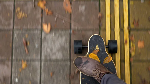 view from above. closeup of male legs in shoes on an electric skateboard
