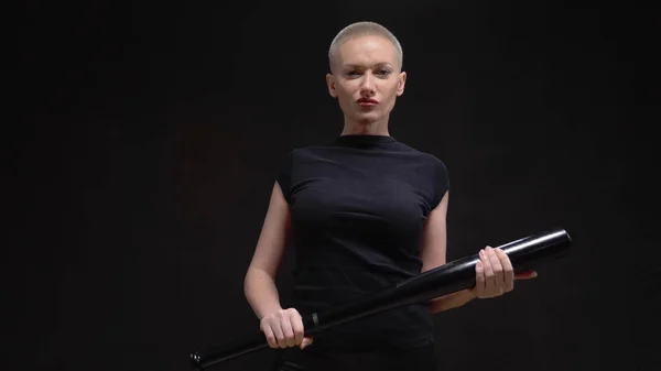 Beautiful short haired blond woman  with a baseball bat on black background — Stock Photo, Image