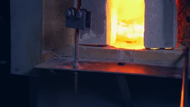 Soffiatore di vetro. produttore di prodotti in vetro. l'uomo riscalda il vetro in un forno — Video Stock