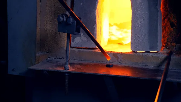 Ventilador de vidro. fabricante de produtos de vidro. o homem aquece o vidro em um forno — Fotografia de Stock