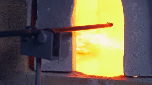 Üvegfúvó. üvegtermékek gyártója. férfi melegíti üveg kemencében — Stock videók
