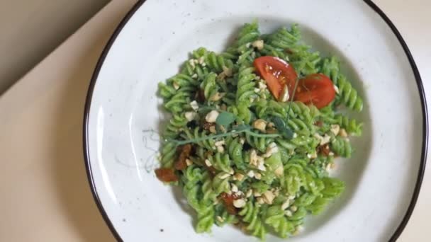 Modieus design voedsel. vegetarische pasta met groene saus en cashewnoten — Stockvideo