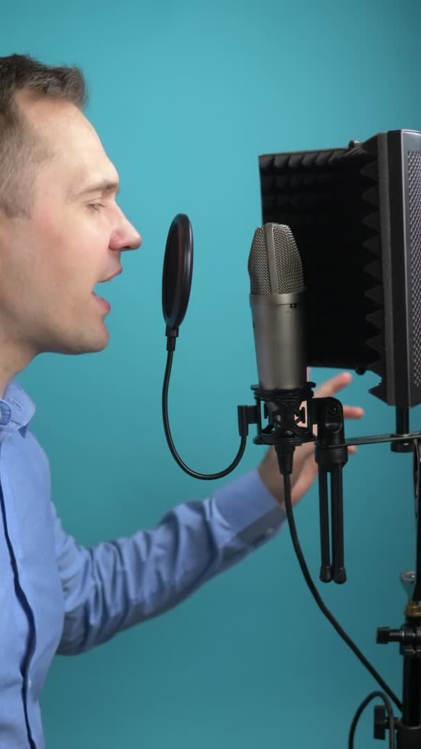 Una imagen vertical. hombre cantando en el micrófono en la grabación Studio — Vídeos de Stock