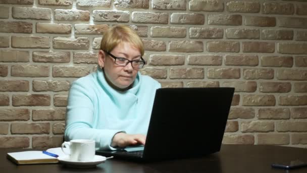 Elderly woman working, using the laptop in the loft. — 비디오