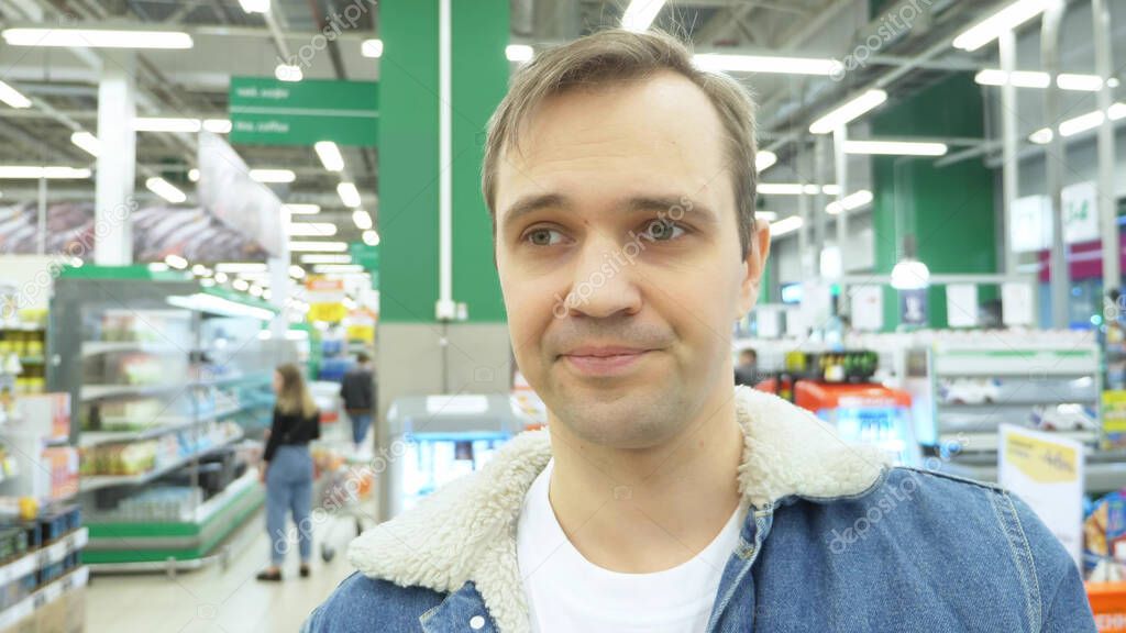 closeup. portrait of tired man in the supermarket. looking around