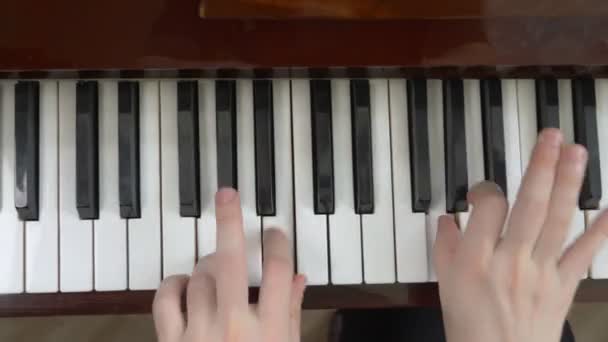 View from above. closeup. female hands masterfully play the piano — Stock Video