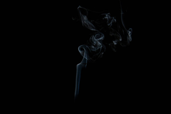 A stream of smoke on a white or black background, rises, bends and makes curls
