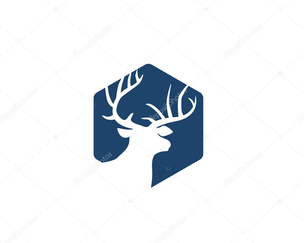 Deer head with antlers as negative space inside hexagon logo