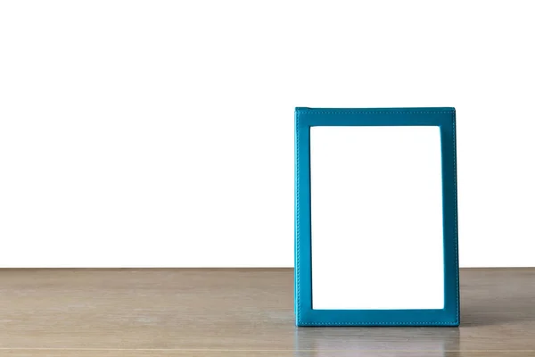 白で隔離木製のテーブルの上を置く空青いパンフレット — ストック写真