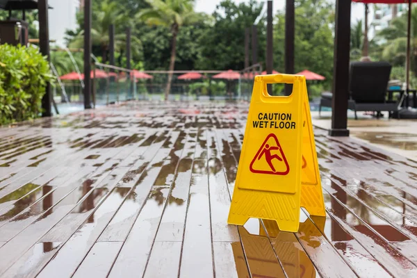 Yellow wet floor warning sign on the floor in hotel — Stock Photo, Image