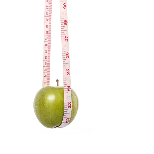 Manzana verde con cinta métrica. Concepto saludable. Captura de estudio —  Fotos de Stock