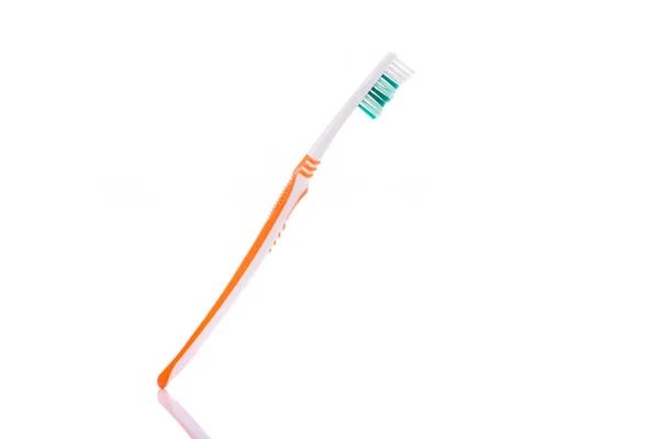 New orange toothbrush. Studio shot isolated on white — Stock Photo, Image