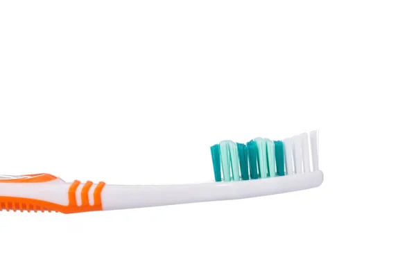 New orange toothbrush. Studio shot isolated on white — Stock Photo, Image