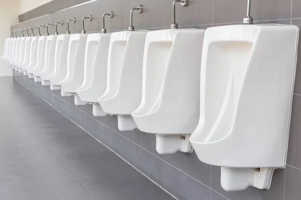 Row of outdoor urinals on grey wall in men public toilet — Stock Photo, Image