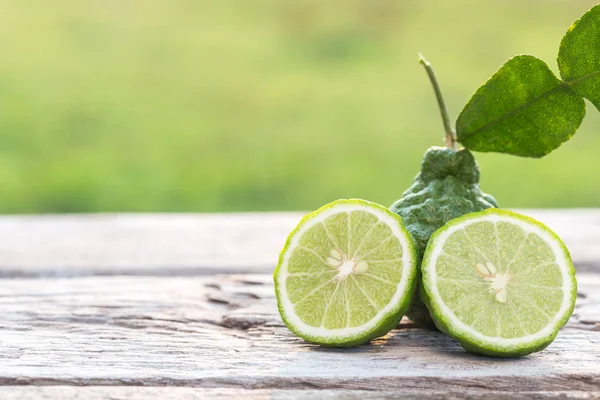 Skiva grön färsk bergamott frukt på träbord bakgrund — Stockfoto