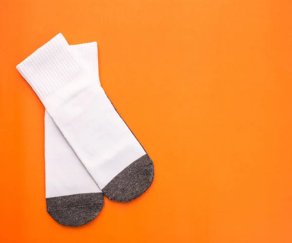 New white student sock on orange background with free space — Stock Photo, Image
