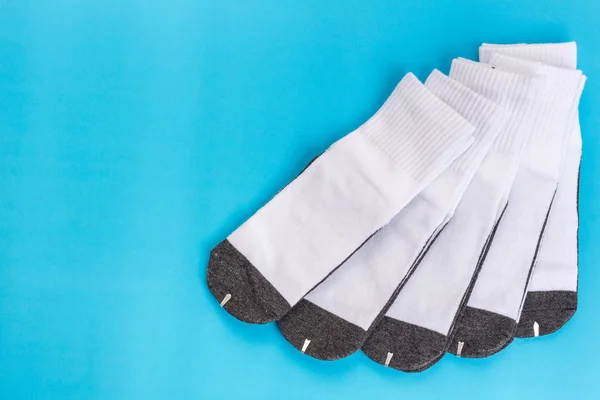 New white student sock on blue background with free space — Stock Photo, Image