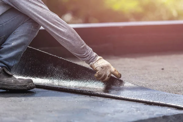 Group of worker installing tar foil on the rooftop of building. — Stock Photo, Image