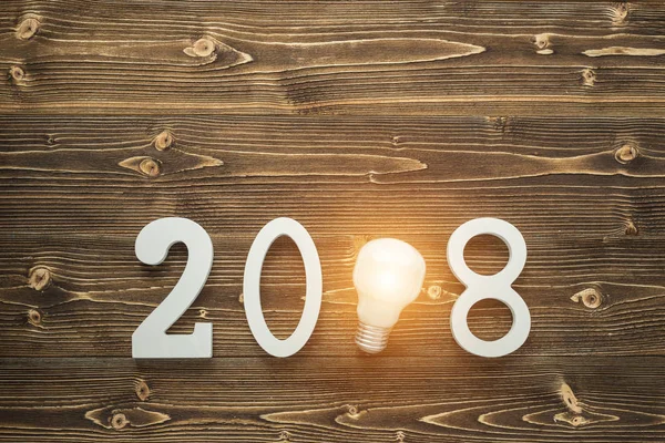 Light bulbs and white number 2018 for new year and holiday conce