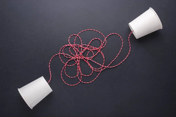 Two white paper cup connect with red rope used for classic phone — Stock Photo, Image