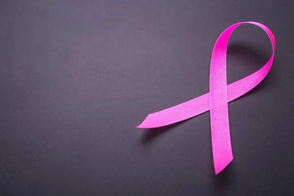 Breast Cancer concept : Pink ribbon symbol of breast cancer on b — Stock Photo, Image