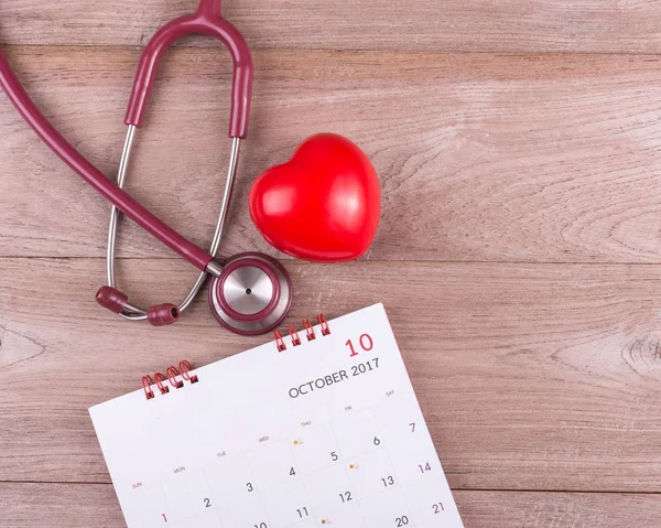 Check heart Concept : Red heart, Calendar and stethoscope on bro