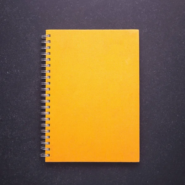 Notebook with blank empty cover on black stone table background. — Stock Photo, Image