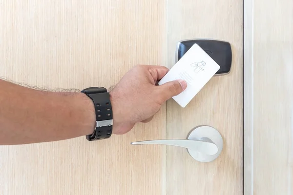 Hand met witte hotel key-card voor de deur van de elektrische — Stockfoto