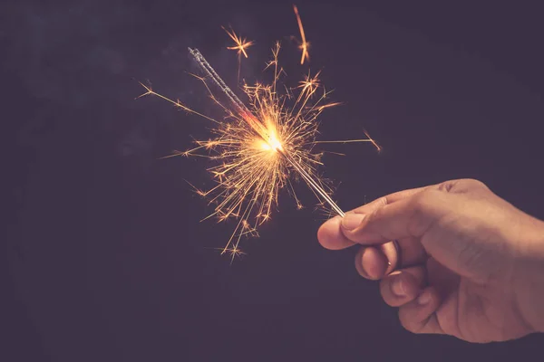 Christmas and new year celebration concept : Hand holding bright — Stock Photo, Image