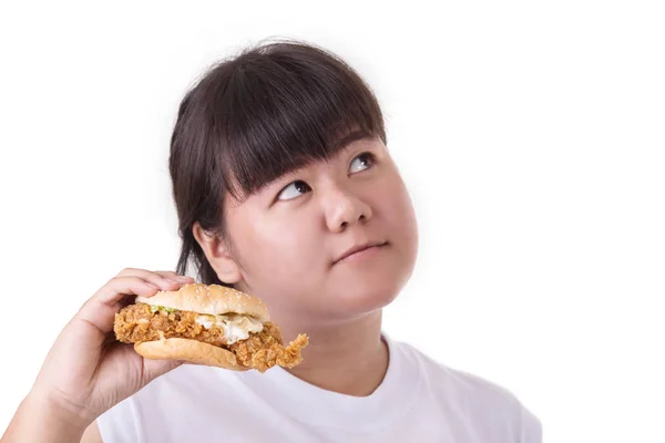 Grasa asiático mujer comer frito pollo hamburguesa aislado en blanco — Foto de Stock