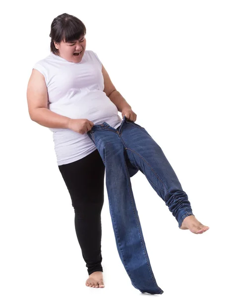 Dikke Aziatische vrouw probeert te dragen kleine grootte jeans geïsoleerd op whit — Stockfoto