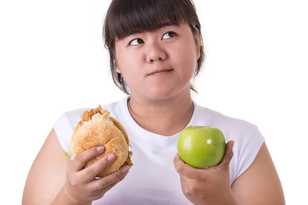 Fat asian woman wearing white t-shirt and choosing to eat fried Royalty Free Stock Images