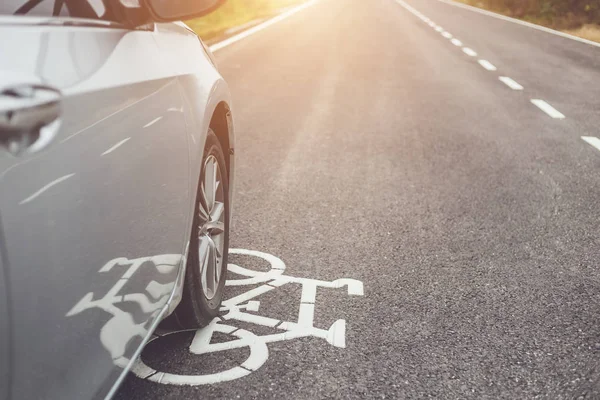 Modern car running on asphalt road / bicycle lane and tread on w — Stock Photo, Image