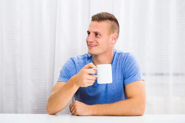 男はコーヒーを飲みながら楽しんでいます — ストック写真