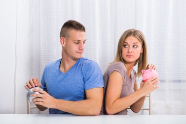 Couple  hiding savings from each other clipart