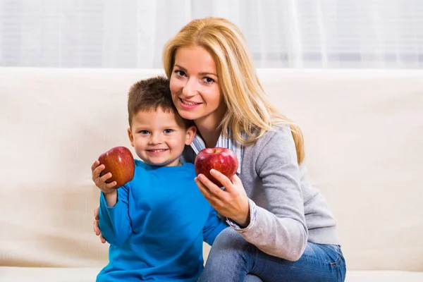 Mother and son eating apple Royalty Free Stock Images