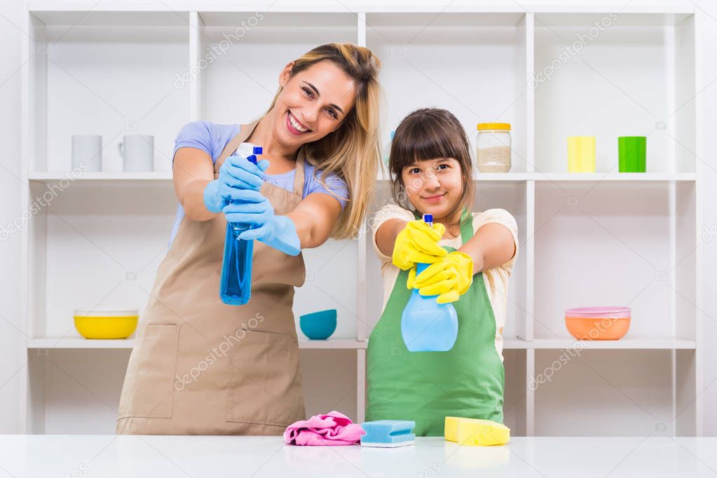 Happy mother and her daughter cleaning 