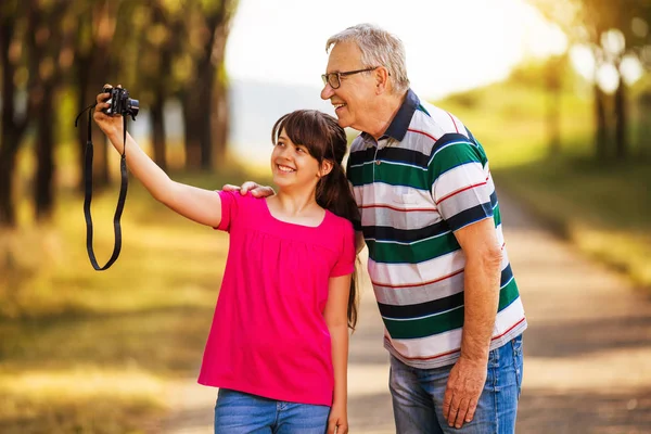 Abuelo y nieta tomando fotos juntos — Foto de Stock