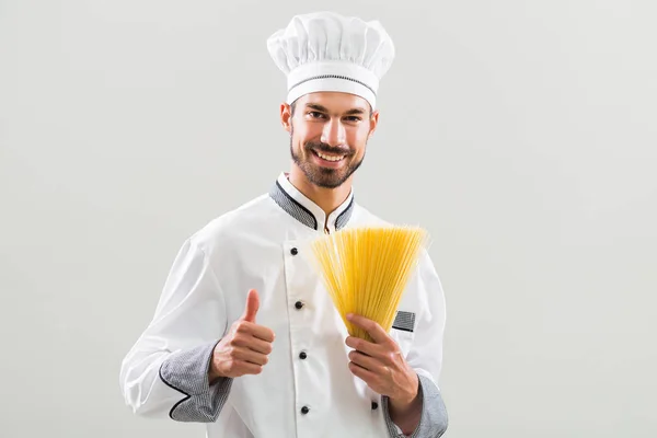 厨师持有意大利面条和显示拇指 — 图库照片