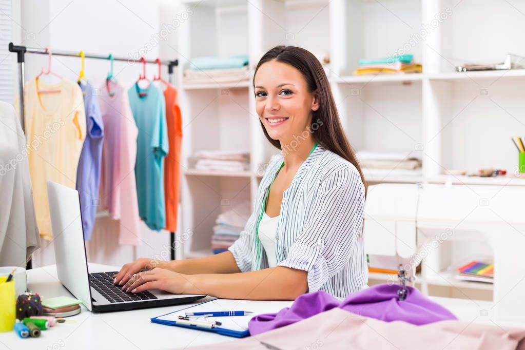 Seamstress using laptop 