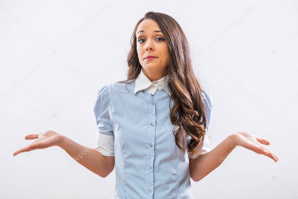 Image of confused businesswoman  shrugging  on gray background.