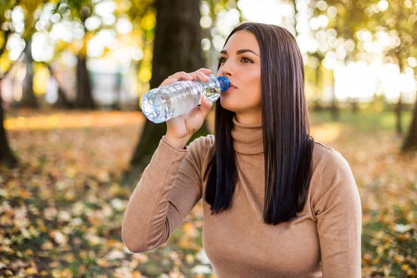 Женщина Пьет Воду Пока Наслаждается Осенью Отдыхает Парке — стоковое фото